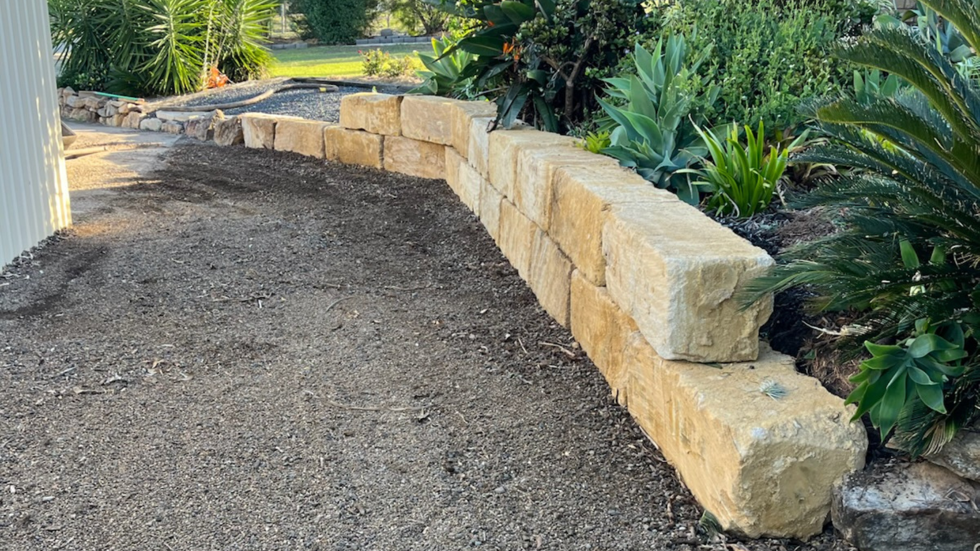 Sandstone block retaining wall. Excavation and earthmoving services